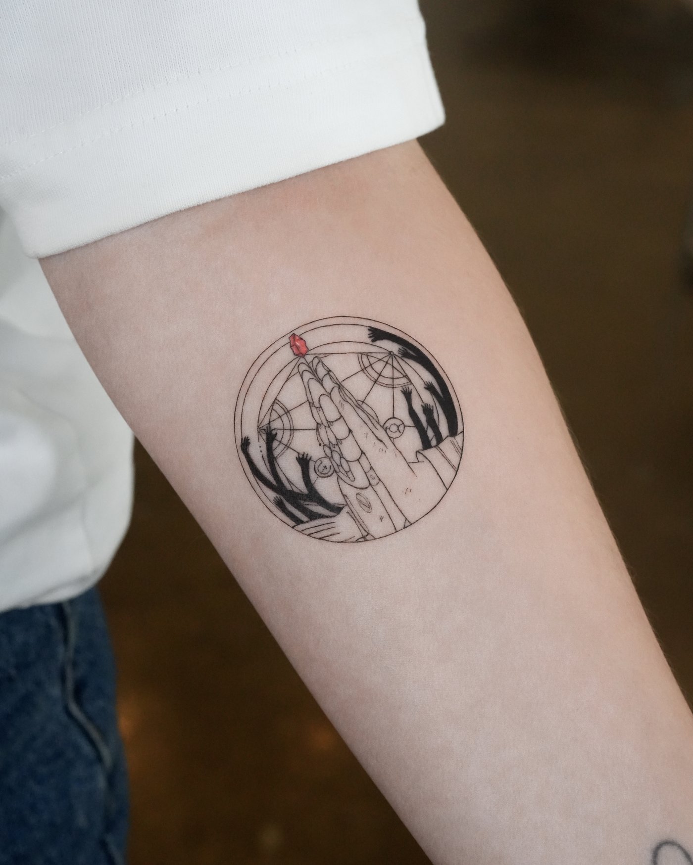 Fine line alchemy circle tattoo with color detail